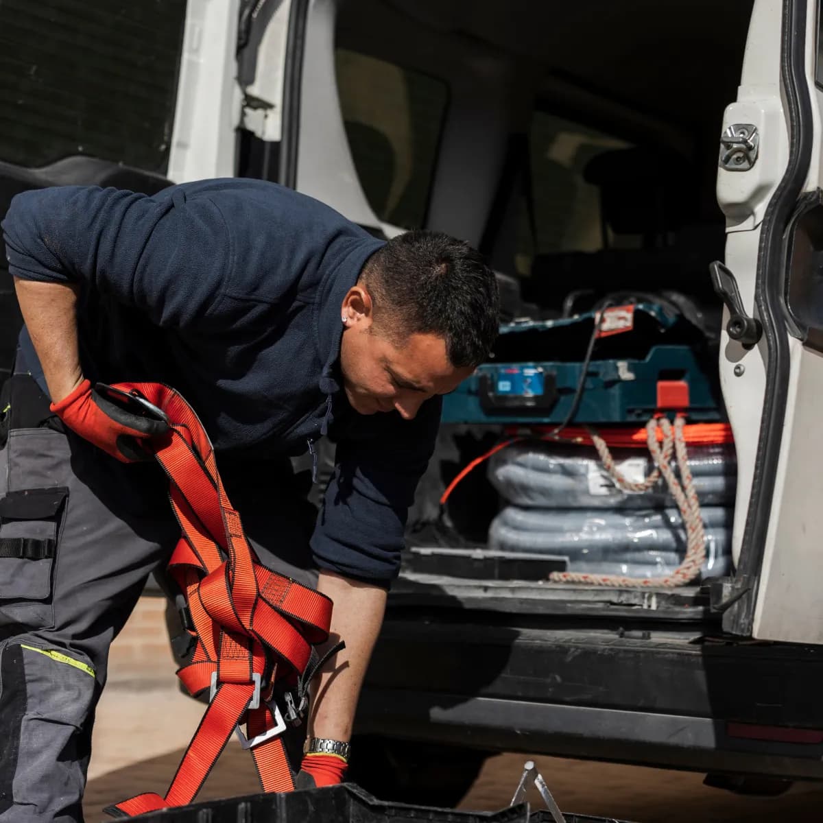 HVAC technician loading equipment